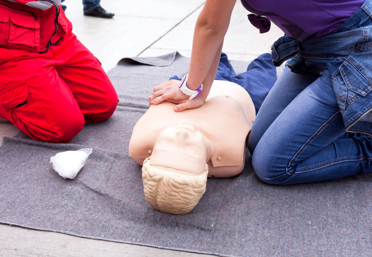 a person doing cpr on a dummy